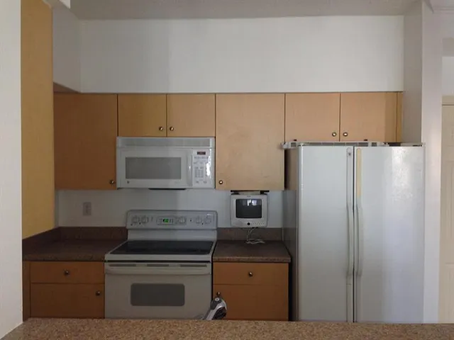 a kitchen with a stove microwave and refrigerator