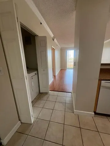 a view of a hallway to rooms and stairs