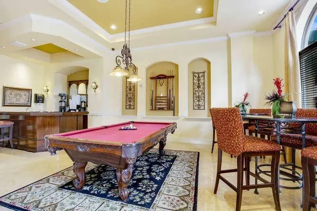 a view of a dining room with furniture and a chandelier