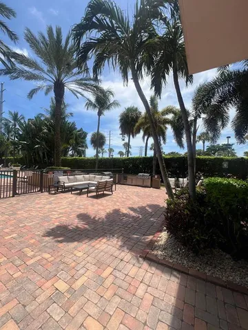 a row of palm trees in front of house
