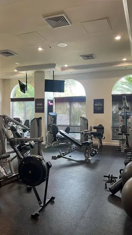 a gym room with lots of chairs and a projector