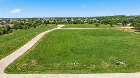 a view of a field with an ocean