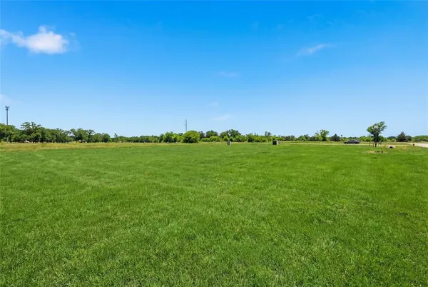 a view of a field with an ocean