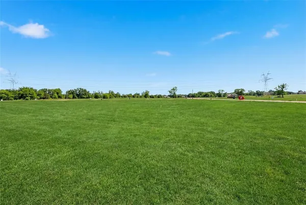 a view of a big yard with a city view