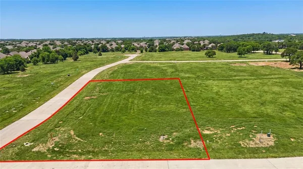 a view of a big yard with an ocean view
