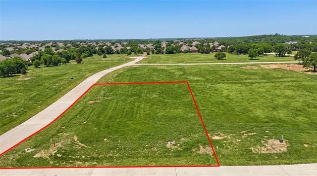 a view of a big yard with an ocean view