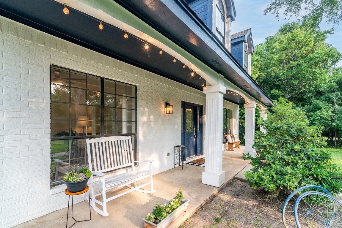a porch with a table and chairs