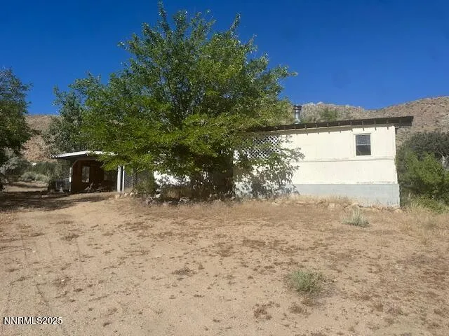 a backyard of a house with plants and trees