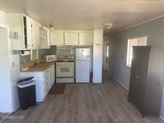 a kitchen with a refrigerator sink and cabinets