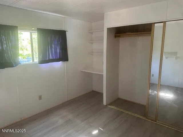an empty room with windows and closet