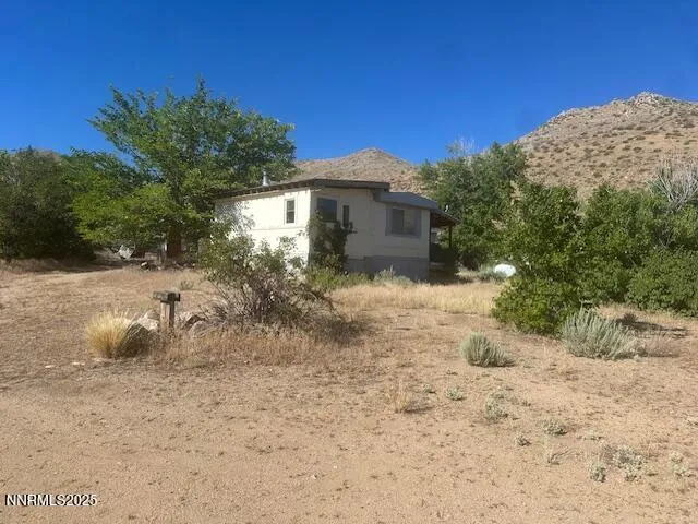 a backyard of a house with large trees