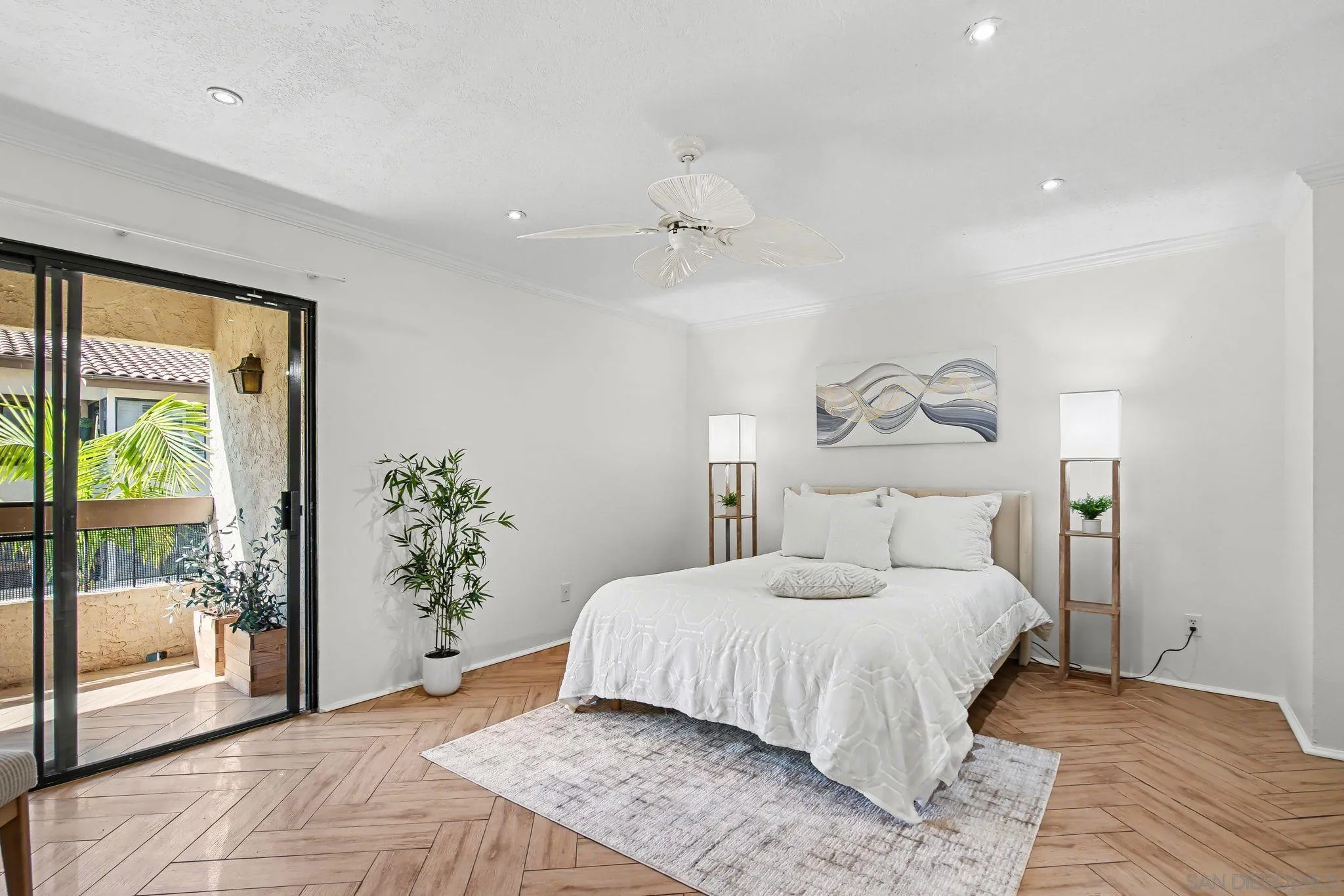 6757 Friars Road, Unit 21 San Diego, CA 92108 - Photo 12 of 40 a bedroom with a large bed and a chandelier