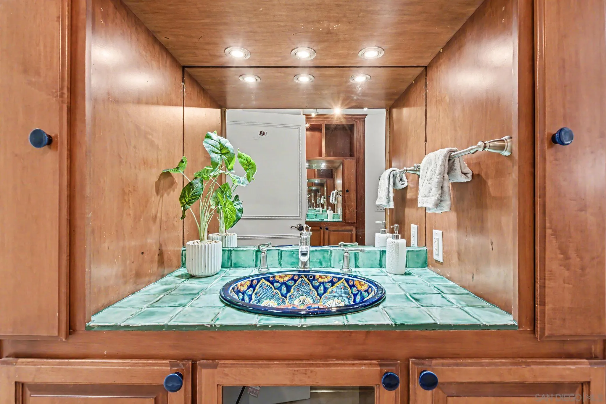 6757 Friars Road, Unit 21 San Diego, CA 92108 - Photo 16 of 40 a bathroom with a granite countertop sink a mirror and shower
