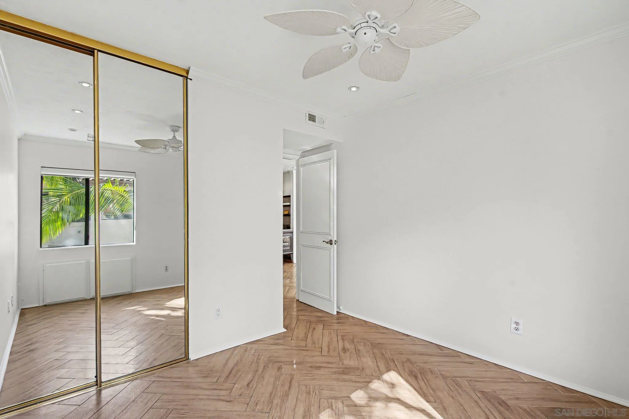 6757 Friars Road, Unit 21 San Diego, CA 92108 - Photo 25 of 40 a view of an empty room with window and a chandelier fan