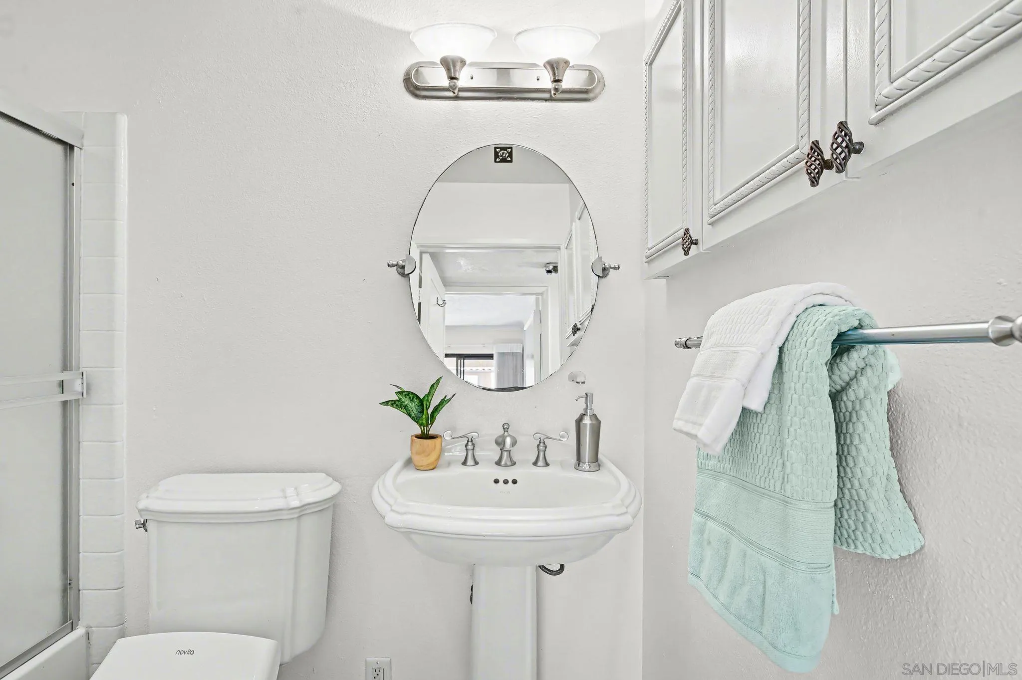 6757 Friars Road, Unit 21 San Diego, CA 92108 - Photo 32 of 40 a bathroom with a sink a toilet and shower