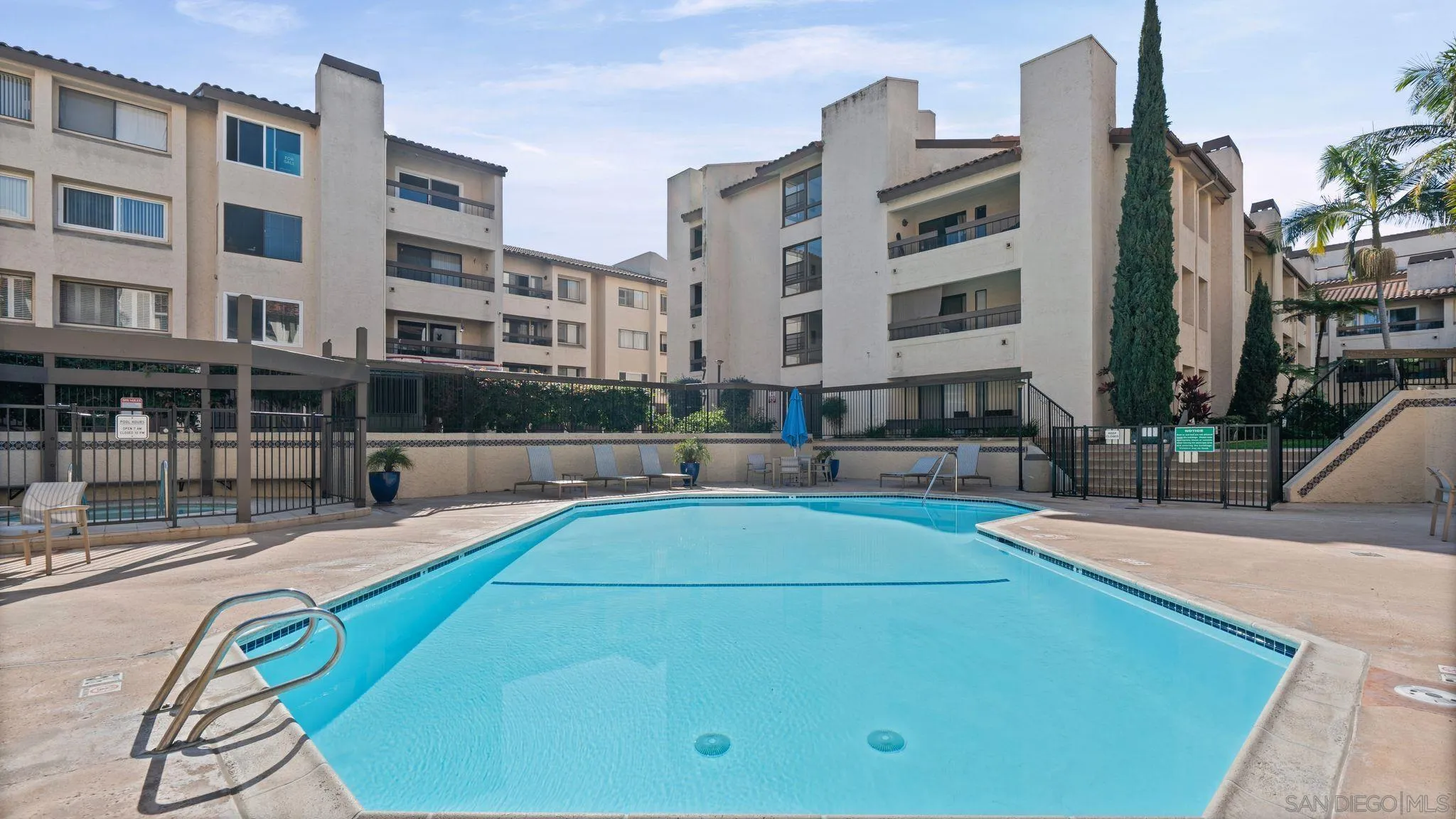 6757 Friars Road, Unit 21 San Diego, CA 92108 - Photo 34 of 40 a view of a swimming pool with a lounge chairs