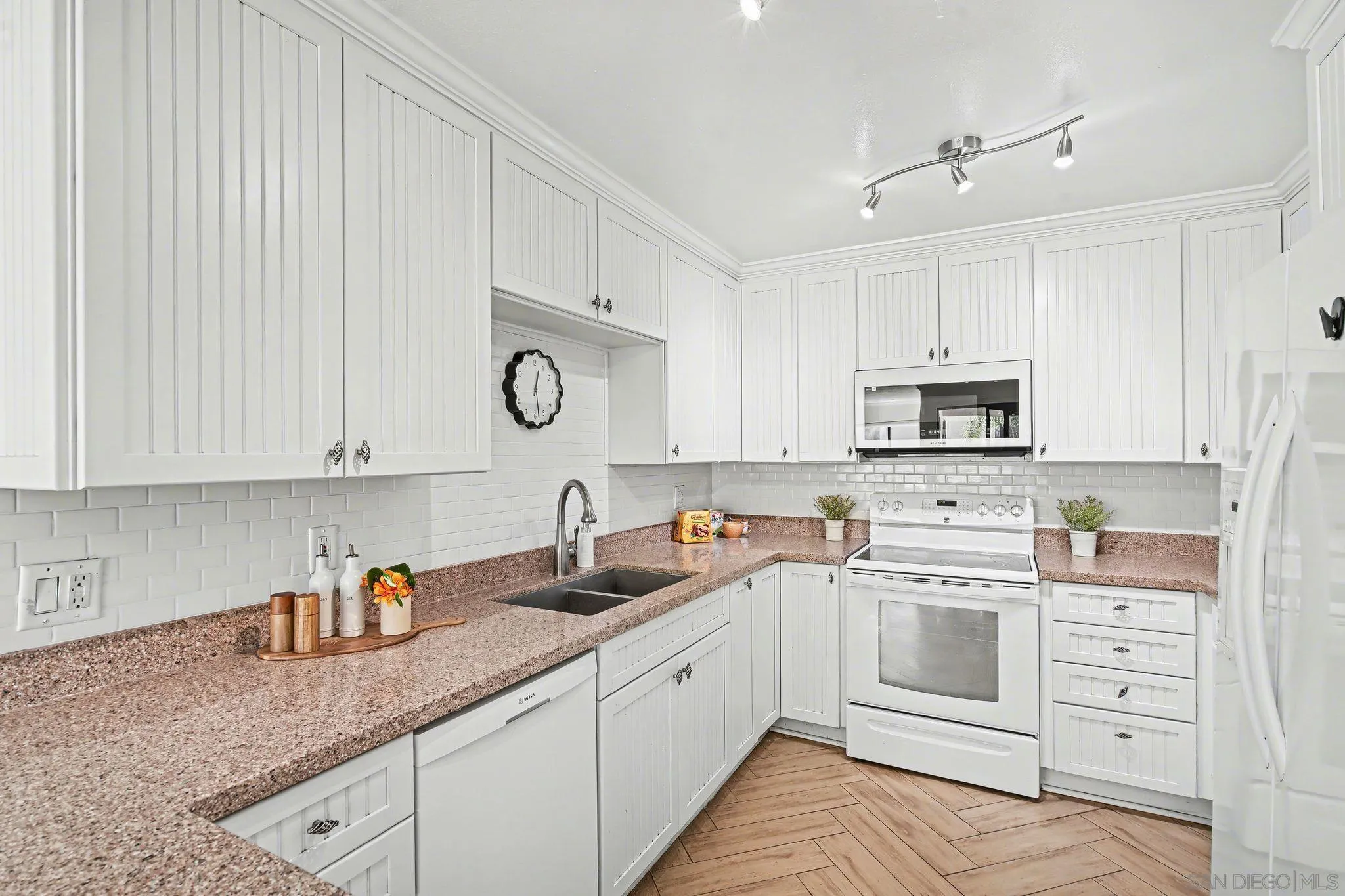 6757 Friars Road, Unit 21 San Diego, CA 92108 - Photo 7 of 40 a kitchen with cabinets appliances a sink and a counter top space