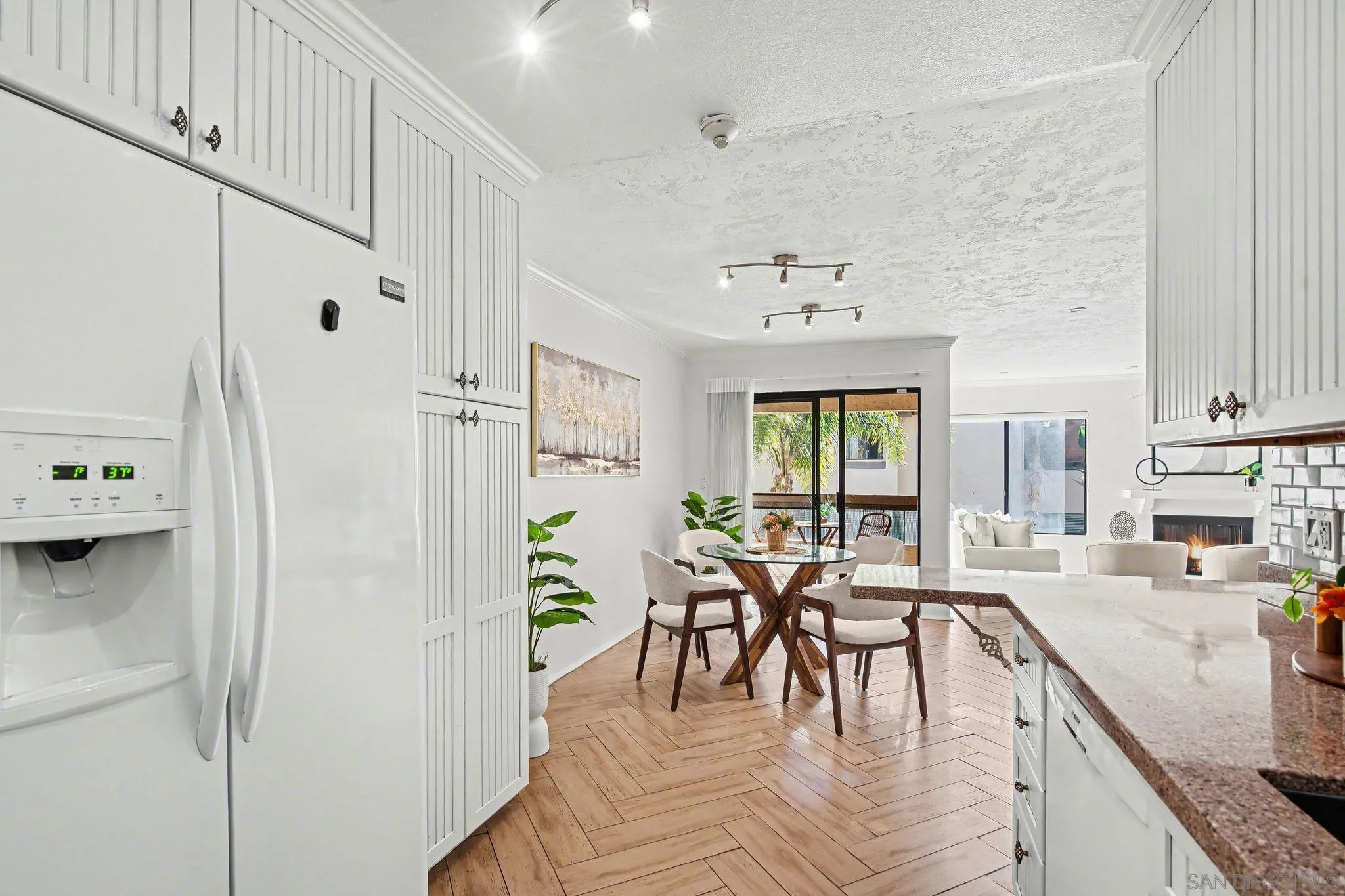 6757 Friars Road, Unit 21 San Diego, CA 92108 - Photo 10 of 40 a view of a kitchen with dining table and chairs