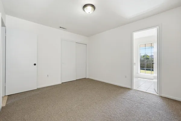 a bathroom with a double vanity sink a toilet and a window