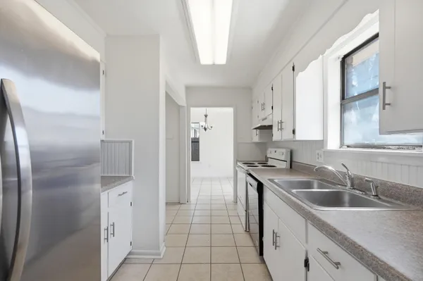 a kitchen with a sink stove and refrigerator
