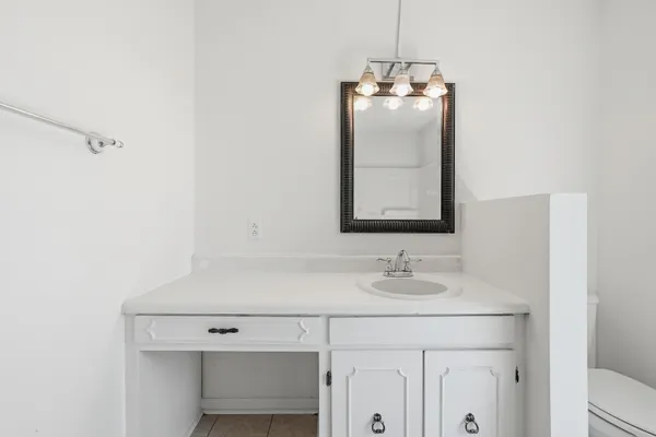 a bathroom with a granite countertop sink a toilet and bathtub