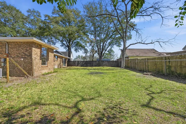 a view of a house with a yard and tree s