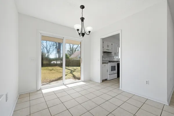 a kitchen with granite countertop white cabinets and a sink