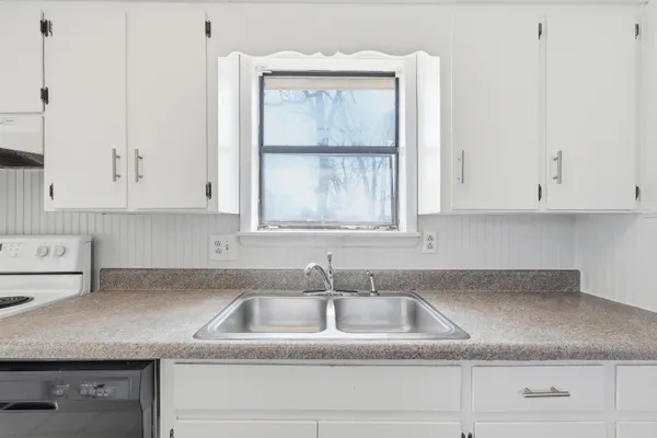 a kitchen with cabinets and a stove top oven