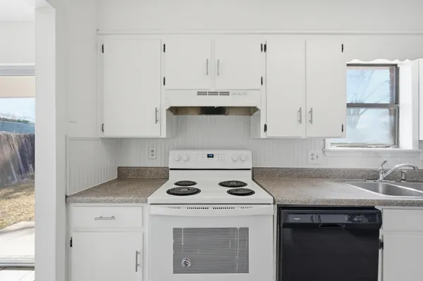 a kitchen with cabinets and stainless steel appliances