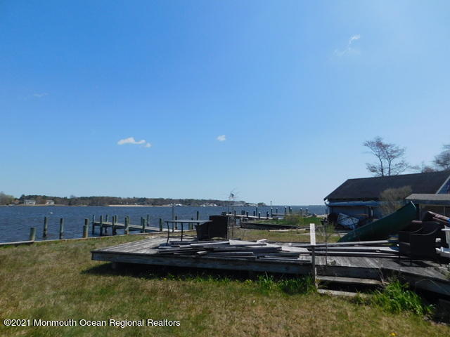 29 Metedeconk Road Brick, NJ 08723 - Photo 12 of 14 a view of a lake with a car parked in front of it