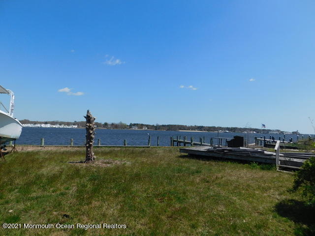 29 Metedeconk Road Brick, NJ 08723 - Photo 8 of 14 a view of a lake with a nearby beach