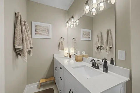 a bathroom with a sink vanity and a mirror