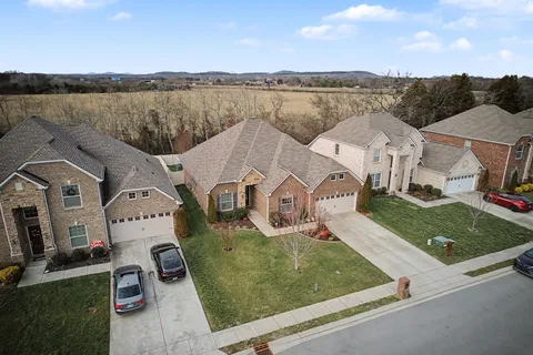 an aerial view of a house with garden space and ocean view