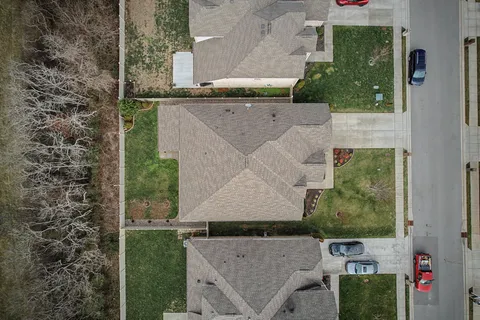 aerial view of a house with a yard