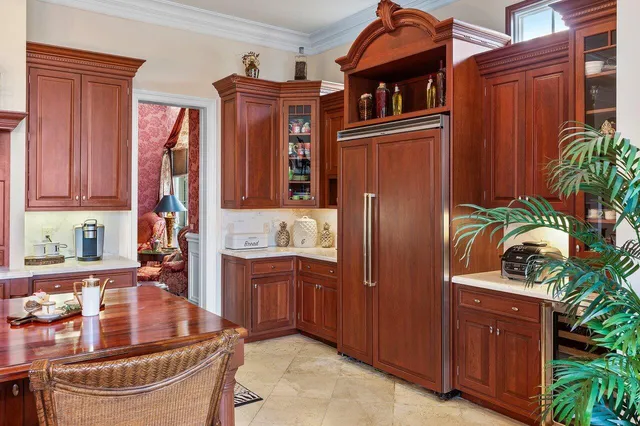a kitchen with stainless steel appliances granite countertop a refrigerator a stove and a wooden cabinets