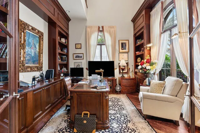 a living room with furniture fireplace and a large window