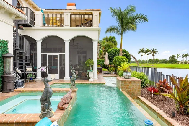 a view of a white house with a big yard and potted plants