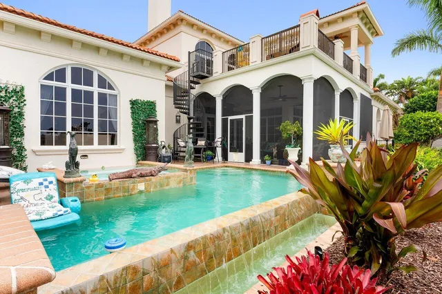 a view of a chairs and table in patio with a swimming pool