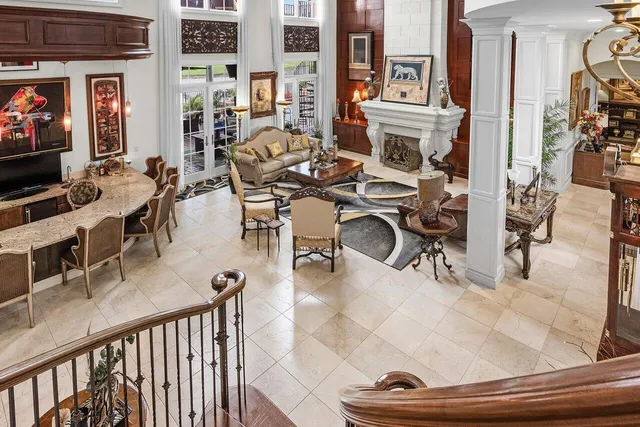 a view of a hallway with wooden floor and windows