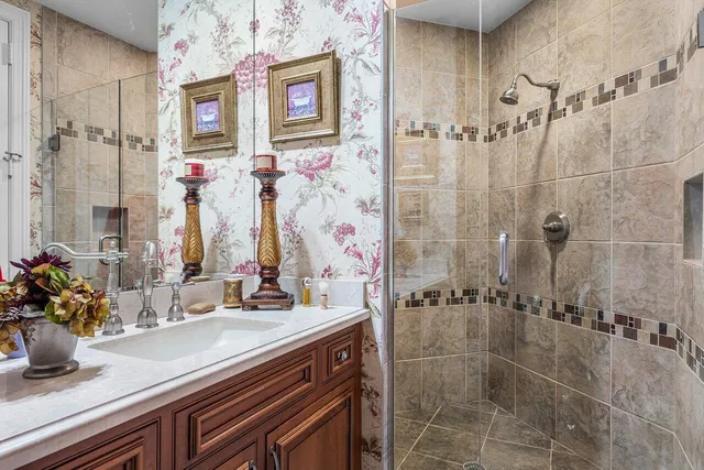 a living room with patio furniture and a chandelier