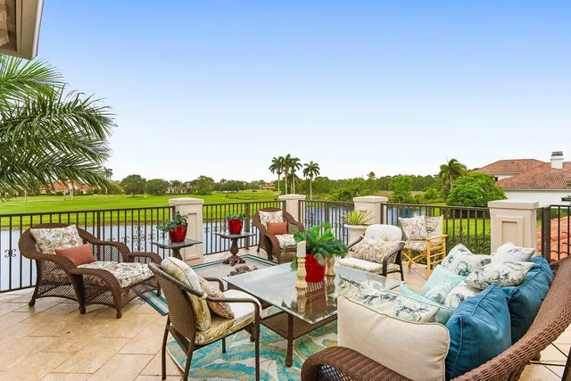 a view of a patio with a table and chairs potted plants with wooden floor