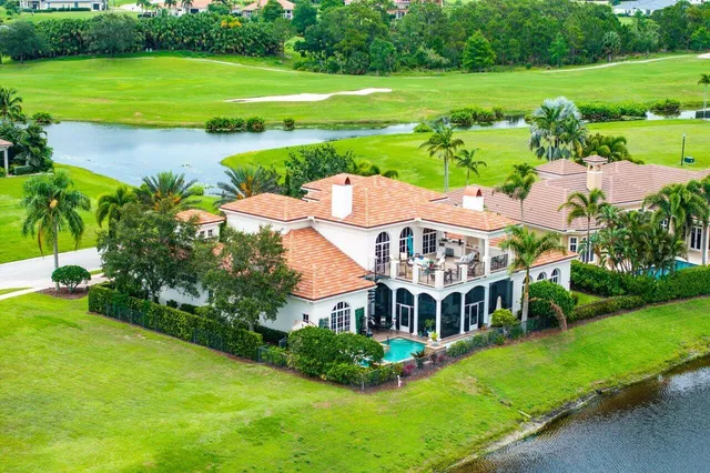 a front view of a house with a yard and potted plants