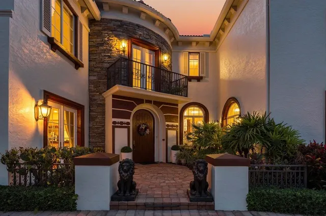 a front view of a house with outdoor seating and plants