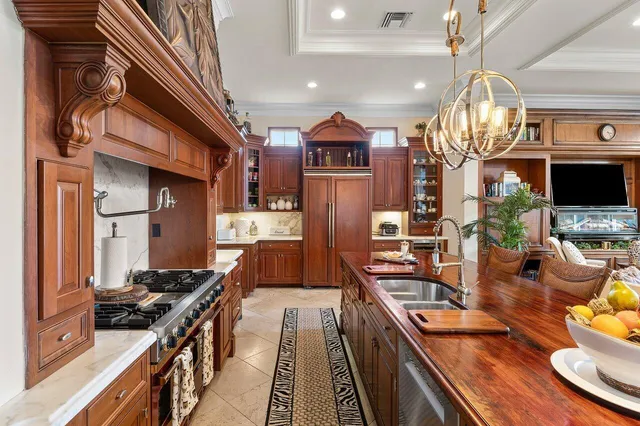 a kitchen with stainless steel appliances granite countertop a stove and a view of living room