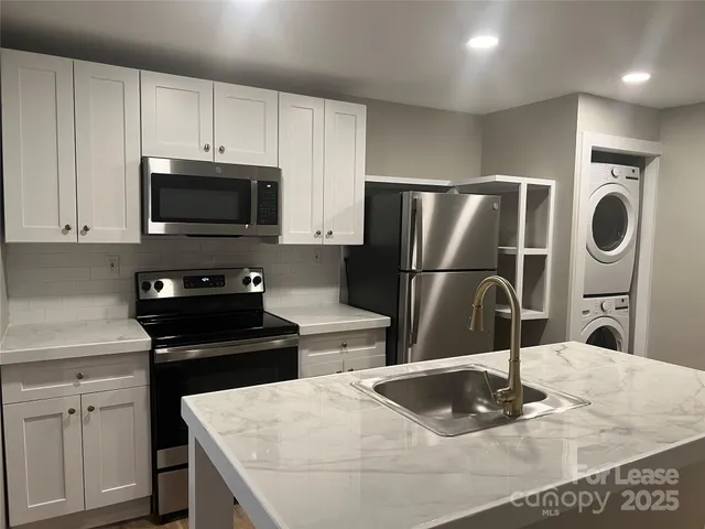 a kitchen with a sink a microwave and refrigerator