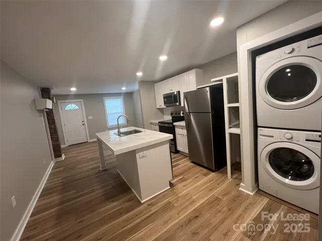 a view of a kitchen with a washer and dryer