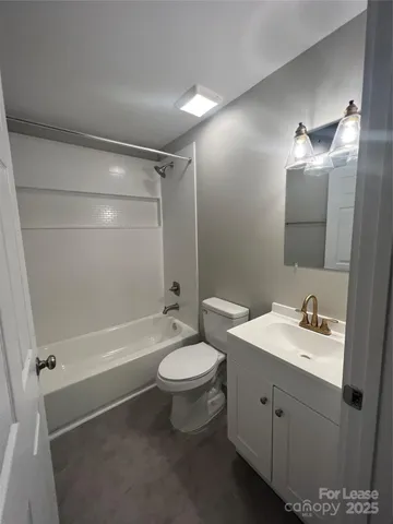 a bathroom with a double vanity sink toilet mirror and shower