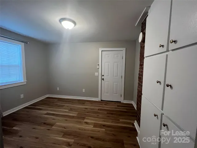 a view of room with window and hardwood floor