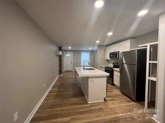 a kitchen with a refrigerator and a sink