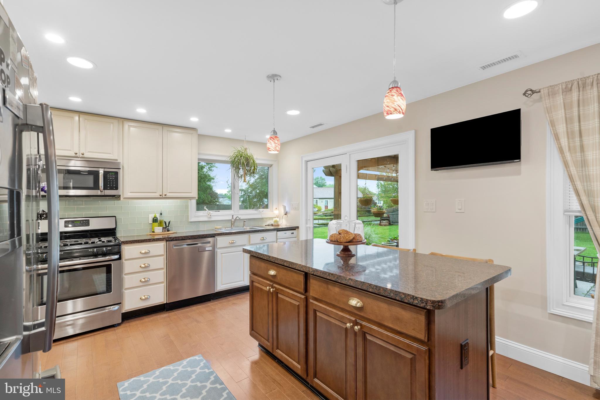 29 Concord Road Marlton, NJ 08053 - Photo 21 of 49 a kitchen with stainless steel appliances granite countertop a sink dishwasher a stove and a refrigerator with wooden floor